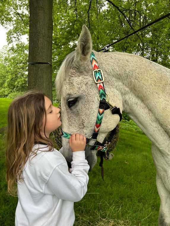 Harper sharing a gentle moment with a horse
