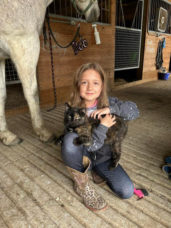 Harper beside a horse