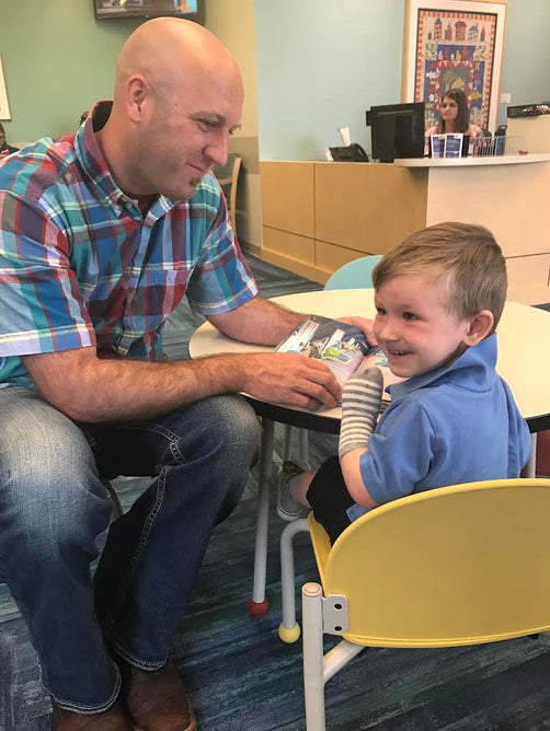 Nathan holding young Hudson at the hospital