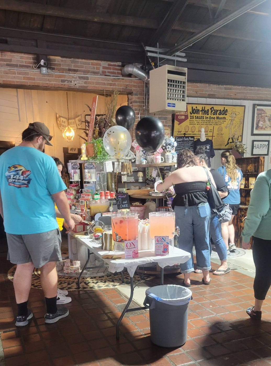 Customers gathering among displays during an event at Merchants On Main